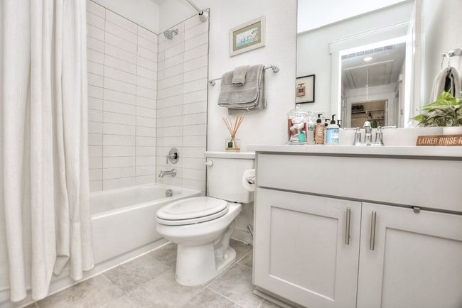 Bathroom featuring tile patterned flooring, shower / tub combo, vanity, and toilet | Image 20