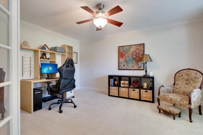 Office/study area with window seat, french doors, and ceiling fan | Image 19