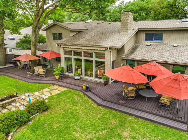 Rear view of house with outdoor dining area, lawn, and trex deck | Image 35