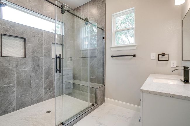 Full bathroom with baseboards, marble finish floor, a stall shower, and vanity | Image 21