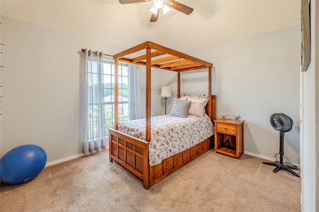 Bedroom with light carpet, baseboards, and ceiling fan | Image 31