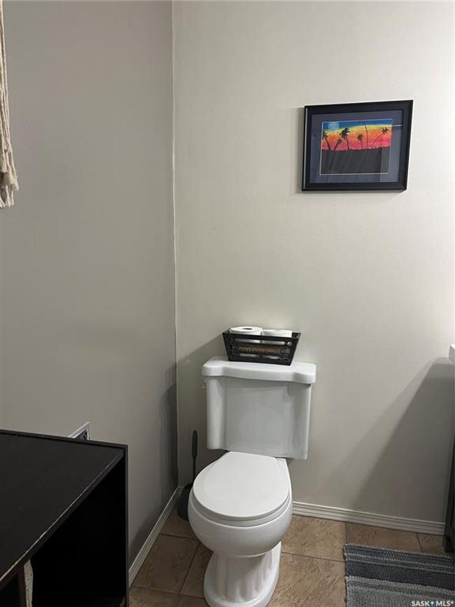 Bathroom with toilet, tile patterned flooring, and baseboards | Image 39
