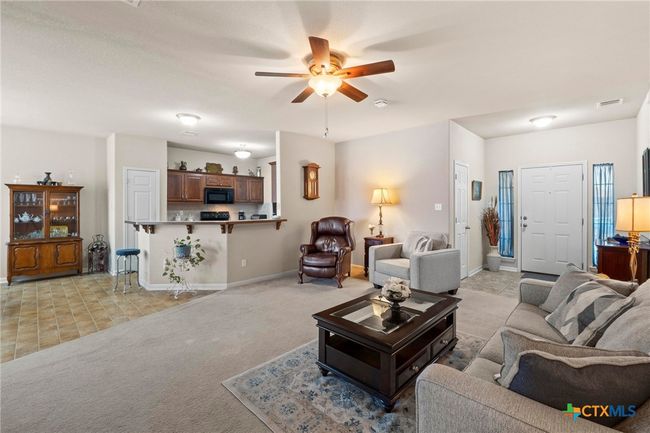living room open to kitchen and dining | Image 6