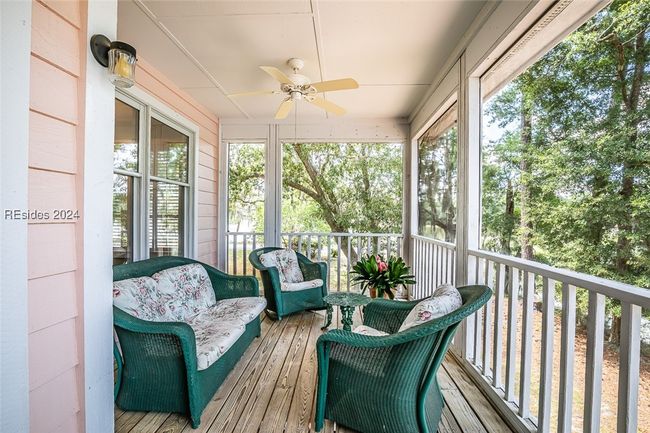 Sunroom featuring plenty of natural light and ceiling fan | Image 45
