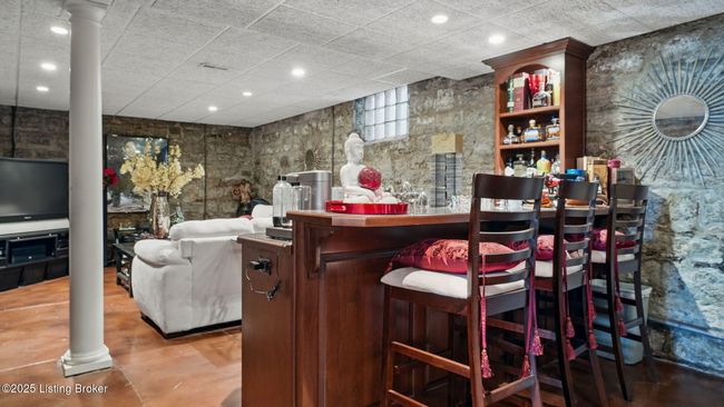 Lower-level living room with wet bar. | Image 37