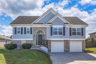 Split foyer home featuring a front lawn and a garage | Image 1