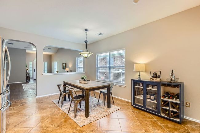 Tiled dining space featuring arched walkways and baseboards | Image 8