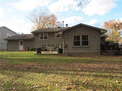 Rear view of property featuring a lawn and a deck | Image 2