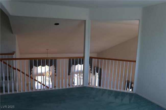 Staircase with carpet floors and lofted ceiling | Image 54