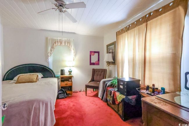 Bedroom featuring carpet flooring, ceiling fan, and wood ceiling | Image 28