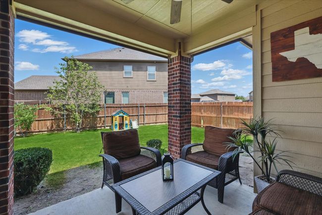 View of patio featuring a fenced backyard and ceiling fan | Image 29