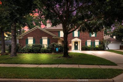 Welcome home to 16838 Country Bridge Road located on a corner lot in the Copperfield Southcreek Village and zoned to Cypress-Fairbanks ISD! This stunning home has lovely curb appeal, a well-manicured lawn, beautiful landscaping, brick elevation, unique front door, covered front porch, traditional style, custom shutters and a double wide driveway! | Image 1