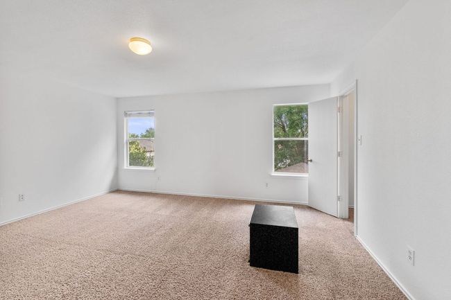 Empty room with healthy amount of natural light, carpet floors, and baseboards | Image 28