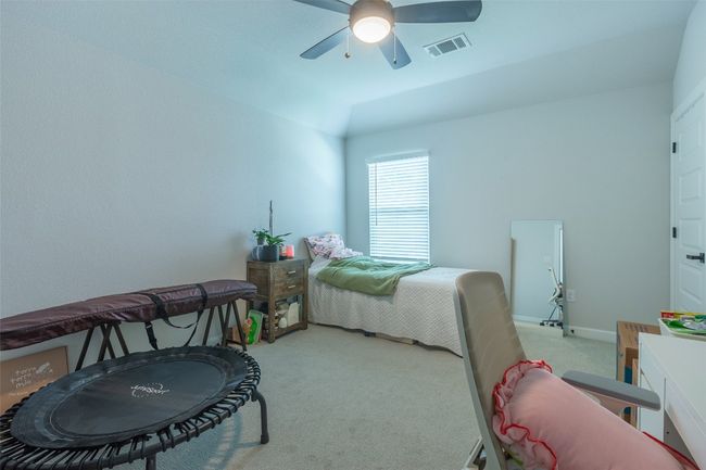 Carpeted bedroom with a ceiling fan and baseboards | Image 24