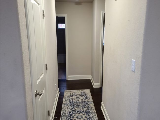 Hallway featuring baseboards and dark wood-type flooring | Image 20