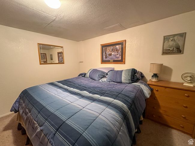 Carpeted bedroom featuring a textured ceiling | Image 21