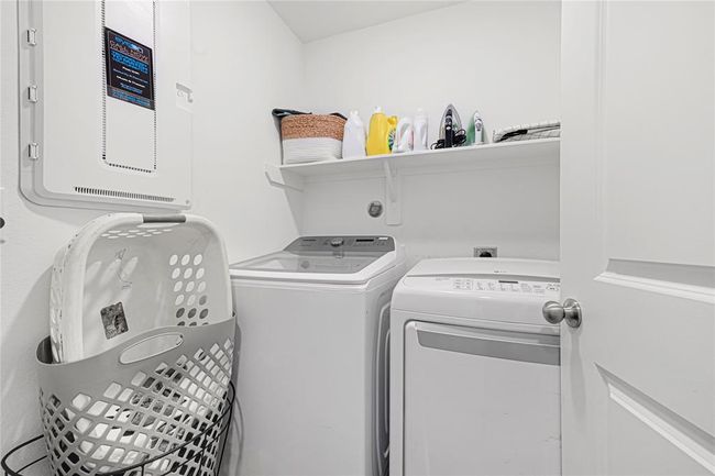 Convenient upstairs laundry room with storage and easy access to bedrooms. | Image 24