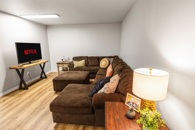 Living room featuring light wood-style flooring and baseboards | Image 38