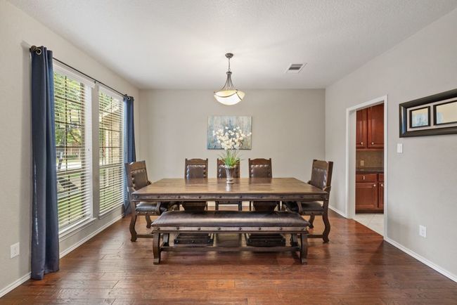 Dining room featuring hardwood / wood-style floors and baseboards | Image 7