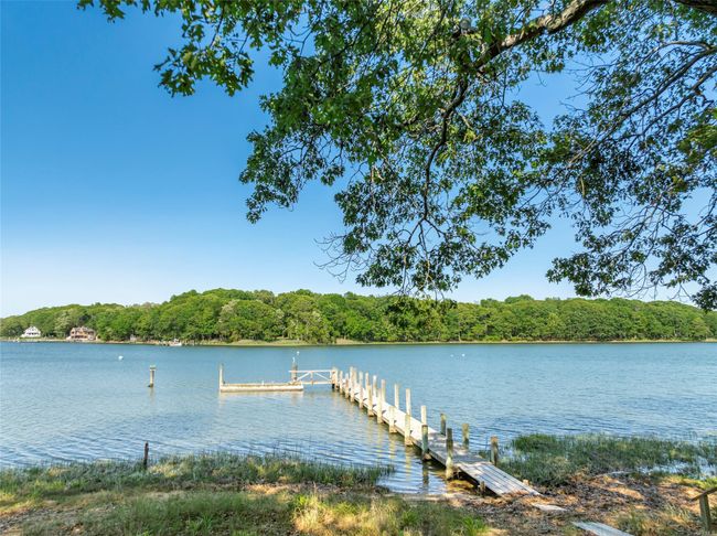 Dock featuring a water view and a view of trees | Image 40