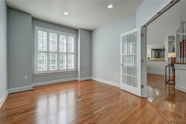 Main-level home office with French doors offers a quiet, private space ideal for remote work or study. | Image 16