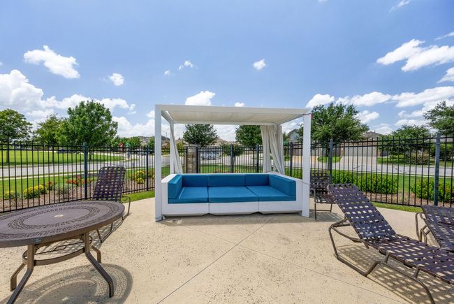 The community pool includes a couple covered seating options. | Image 29