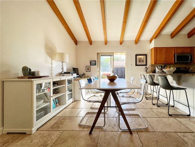 DRAMATIC DINING AND KITCHEN AREA. PASS THRU BAR TO KITCHEN. STONE FLOORS. VAULTED WOOD BEAM CEILINGS | Image 6