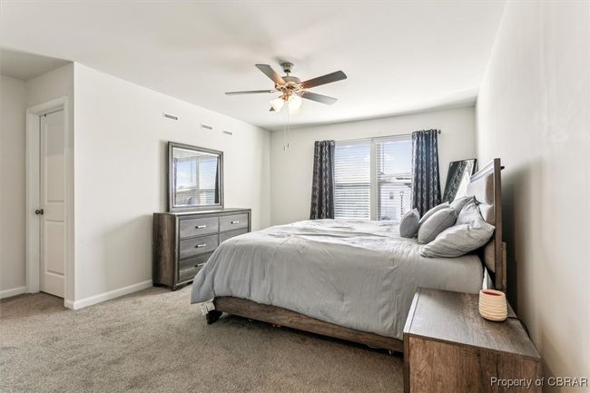 Bedroom with visible vents, carpet flooring, baseboards, and a ceiling fan | Image 15