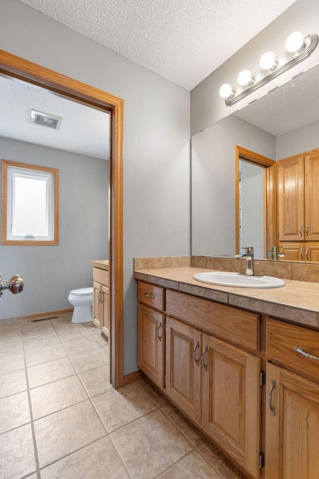 The upper-level also includes a full bathroom and two sinks. | Image 26