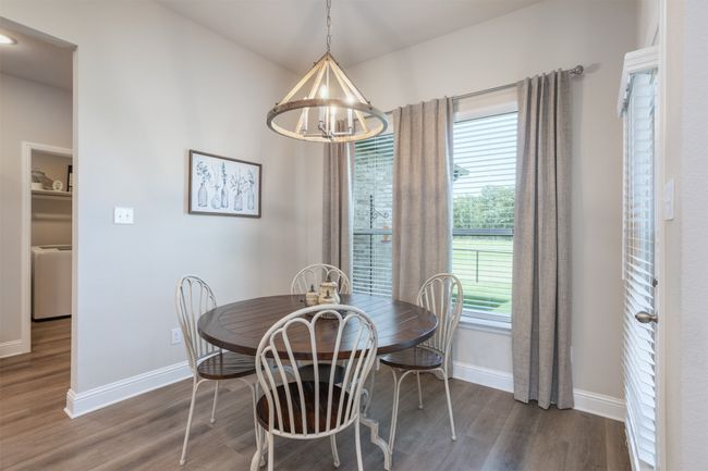 The dining area is at the back of the home and provides lovely views of the nature that surrounds your home. | Image 11