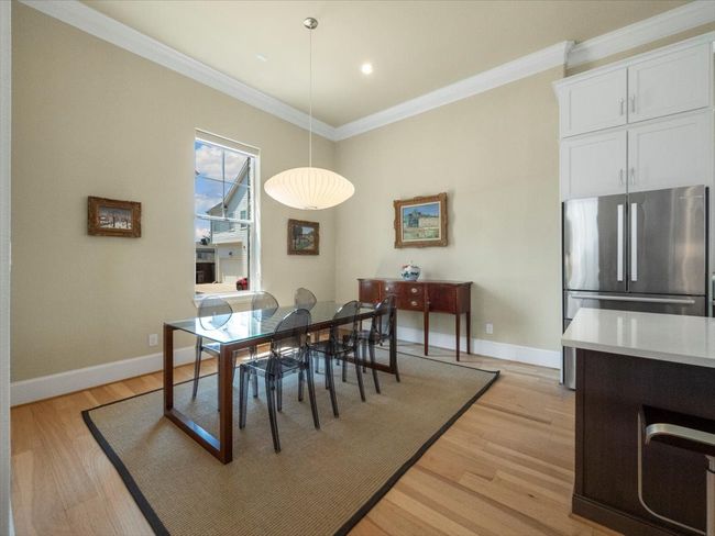 Dining area with crown molding, light wood finished floors, baseboards, and recessed lighting | Image 7