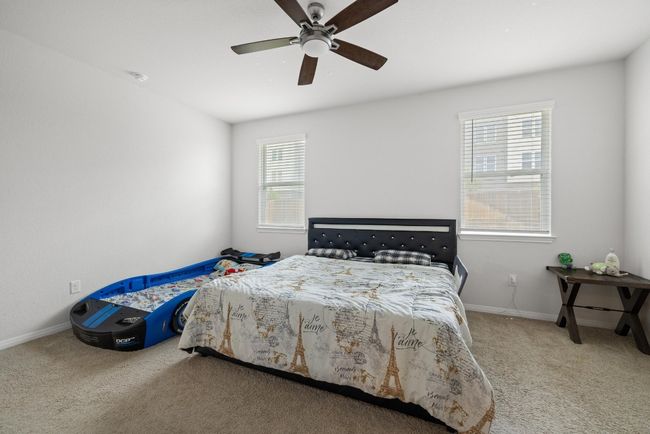 Bedroom featuring carpet floors, baseboards, and ceiling fan | Image 15