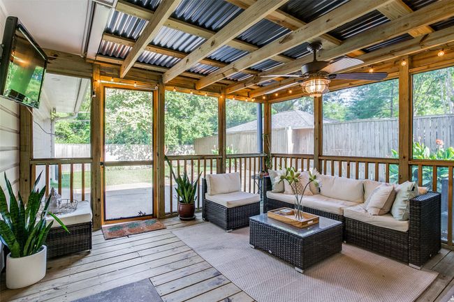 Sunroom featuring ceiling fan and an outdoor hangout area | Image 23