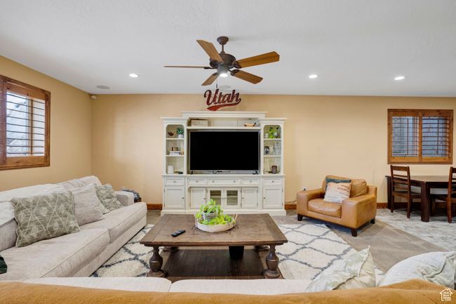 Living room featuring baseboards, ceiling fan, recessed lighting, and light carpet | Image 31