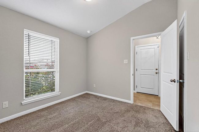 Spare room featuring vaulted ceiling, healthy amount of natural light, light carpet, and light tile patterned floors | Image 30