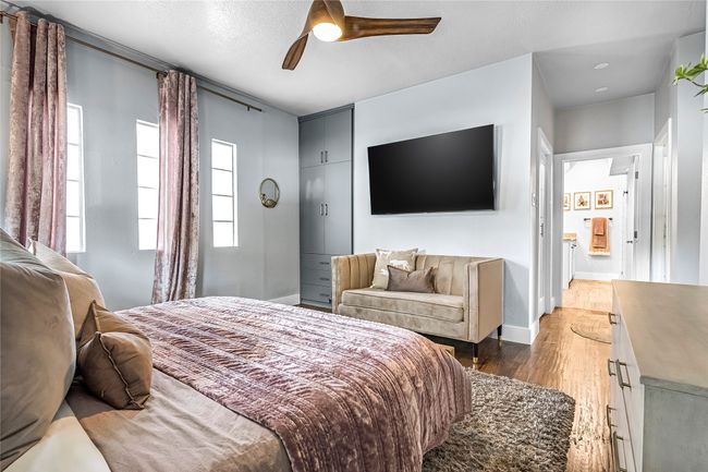 Bedroom with wood finished floors, a ceiling fan, and baseboards | Image 14