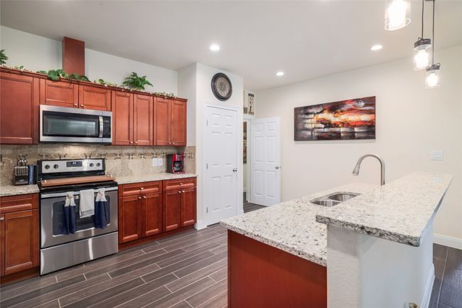 You can have multiple chefs cooking in this kitchen: one on the island, one in the stove, and one on the countertop. | Image 15