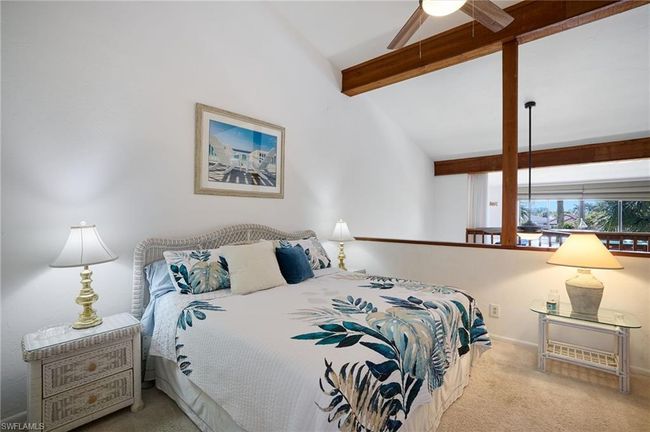 Bedroom featuring light carpet, lofted ceiling with beams, and ceiling fan | Image 13