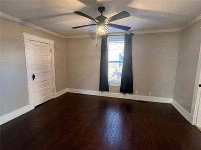 Spare room with ornamental molding, ceiling fan, and dark hardwood / wood-style floors | Image 3