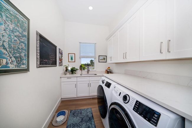 Laundry room, complete with plenty of storage and laundry sink | Image 61