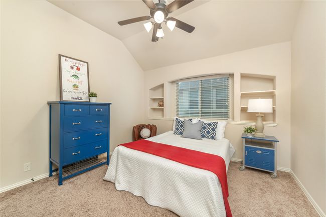 Carpeted bedroom with lofted ceiling, baseboards, and a ceiling fan | Image 27