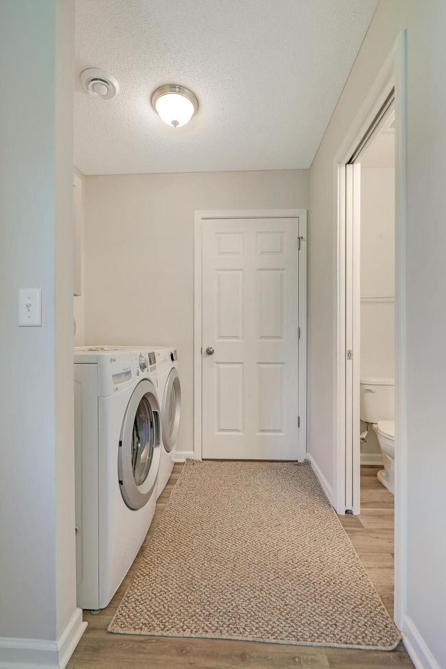 Enjoy the convenience of a finished laundry room complete with built-in cabinetry for organized storage and functionality. | Image 33