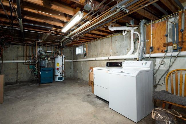 Basement featuring water heater, independent washer and dryer, and a heating unit | Image 25