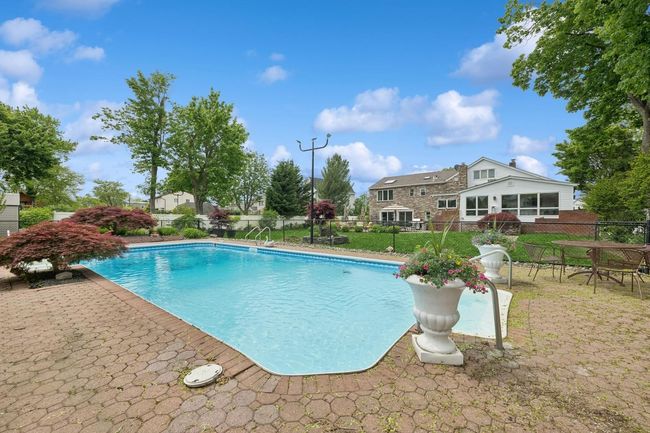 View of swimming pool featuring fence and a patio | Image 31