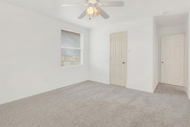 Unfurnished bedroom with carpet floors, baseboards, and ceiling fan | Image 29