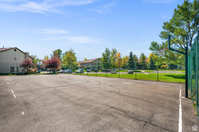 Uncovered parking lot featuring community basketball court and a residential view | Image 29