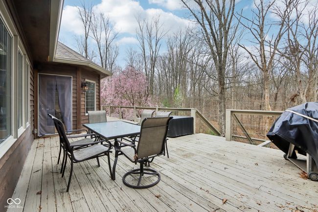 wooden terrace featuring a grill and outdoor dining space | Image 52