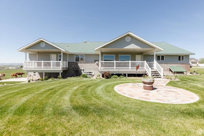 View of front of home with a front lawn and a fire pit | Image 16