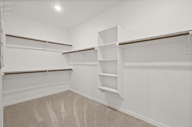 Spacious closet with carpet flooring | Image 17