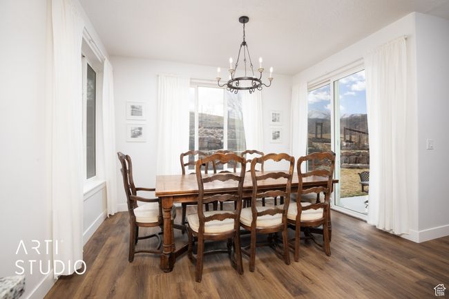 Dining room with plenty of natural light, dark hardwood / wood-style flooring, and a notable chandelier | Image 13